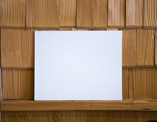 White frame on wooden wall background, mock up