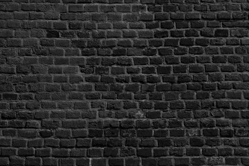 Fototapeta na wymiar The background of the old black brick wall for design interior