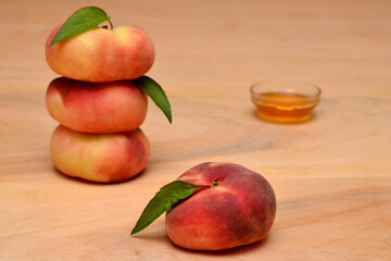 summer still life with fruit flat peaches and honey on the table