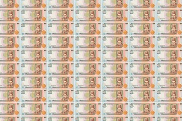 100 Ukrainian hryvnias bills printed in money production conveyor. Collage of many bills. Concept...