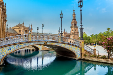 Fototapeta na wymiar An art deco bridge on the southern side of the Plaza de Espana in Seville, Spain in the early morning in summertime