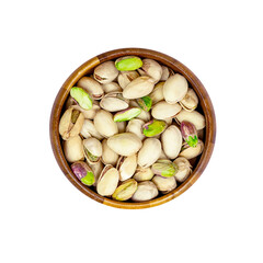 Top view of roasted salted pistachio nuts in nutshell in the round brown wooden bowl isolated on white background.