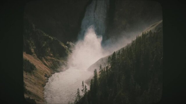 A view of Upper Yellowstone Falls and a rainbow in Yellowstone National Park. Vintage Film Look.