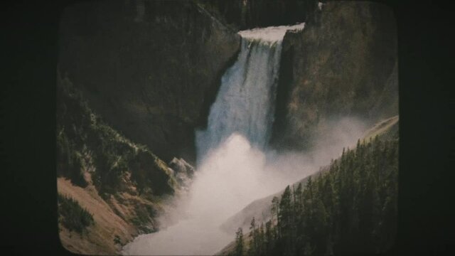 A view of Upper Yellowstone Falls and a rainbow in Yellowstone National Park. Vintage Film Look.