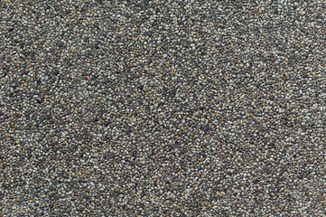 Closeup of exposed concrete made of small pebbles in different shades of brown and gray