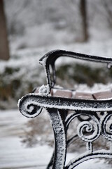 lonely bench covered with snow on christmas eve closeup