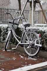 a lonely bicycle covered in snow at the backyard parking during winter christmas eve holidays