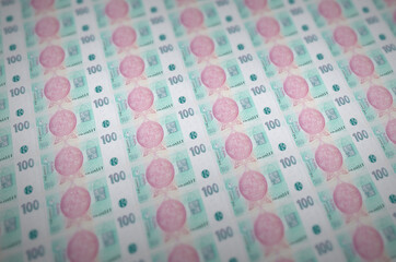 100 Czech korun bills printed in illegal money production conveyor. Collage of many fake bills....