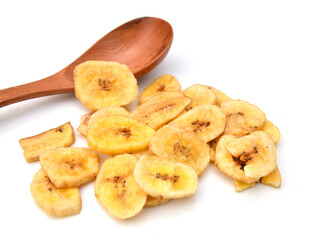 Banana chips and wooden spoon on white background