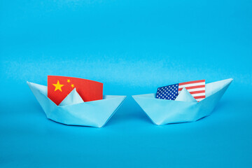 paper ship with Flags of USA and China concept of conflict, shipment or free trade agreement and membership