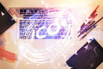 Blockchain theme hologram drawings over computer on the desktop background. Top view. Multi exposure. Concept of cryptoeconomy.