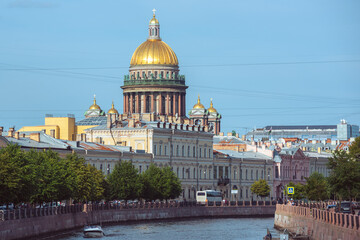 Fototapeta na wymiar Saint Petersburg, Russia: famous St. Isaac's Cathedral and the old town houses along the Moyka River.