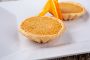 A view of a plate of Caribbean coconut tarts, in a restaurant or kitchen setting.