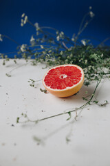 Slice of grapefruit on a table with herb