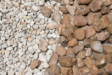 brown river bed rocks next to white and broken pebbles