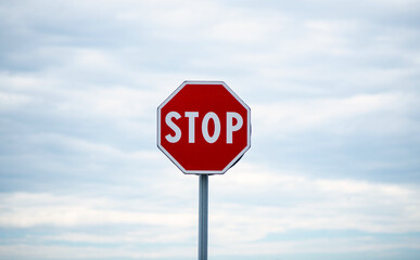 stop sign on cloudy sky background