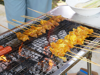 Malaysian famous traditional food called sate. Meat or chicken marinated with mix spices and grill using hot charcoal. Grill in action.