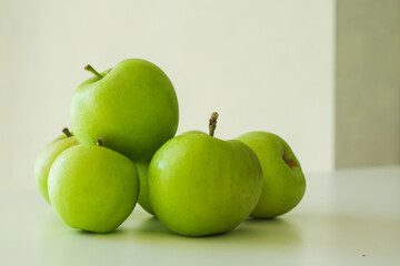 Tasty green apples on light background