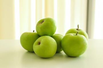 Tasty green apples on light background