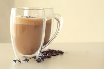 Tasty coffee with lavender on light background