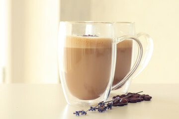 Tasty coffee with lavender on light background