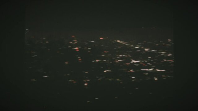 4th of July fireworks at night in Los Angeles from a high angle view at the Griffith observatory. Vintage Film Look. 