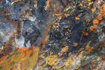 Full-screen texture of fractured variegated red-yellow Jasper with translucent chalcedony and...