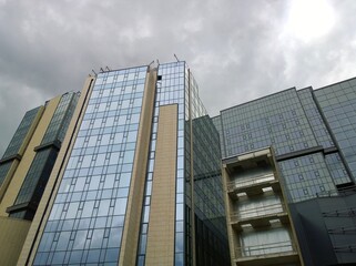 Obraz premium Buildings of new expo and convention corporate business center. Glass exterior. Rental commercial real estate. Cityscape. Office park. Overcast sky. Economic and financial concept. Urban architecture.