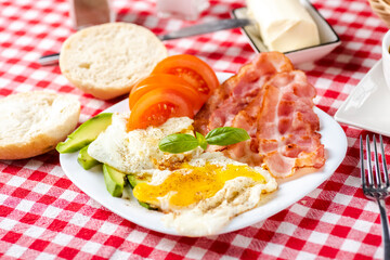 bacon and eggs with avocado and tomato, bread and coffee