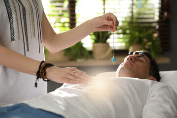 Man during crystal healing session in therapy room