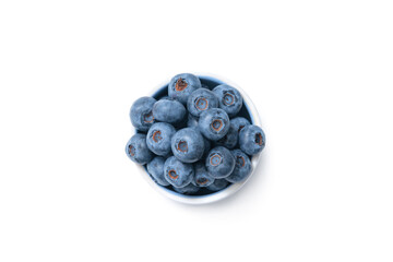 Close up of bowl full of blueberries isolated on white background. Ripe blueberry plate. Organic and healthy food.