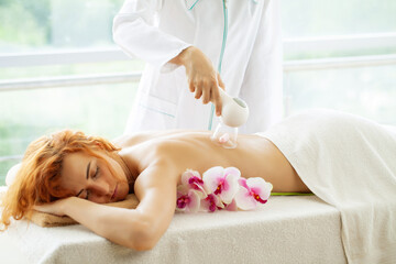 Obraz na płótnie Canvas Woman getting lpg massage on back in beauty clinic