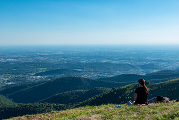 Fototapeta na wymiar Hiker admiring the landscape from mount Bolettone