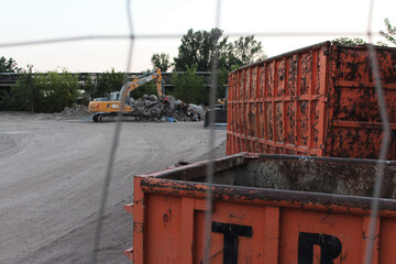 old orange metal rubble containers