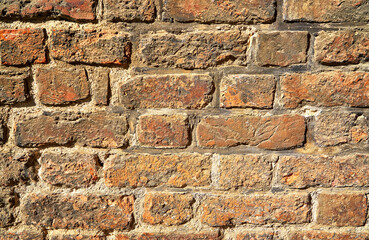 Weathered stained old brick wall background.