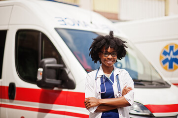 African american female paramedic standing in front of ambulance car. © AS Photo Family