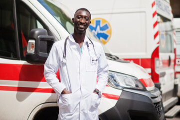 African male paramedic standing in front of ambulance car. © AS Photo Family