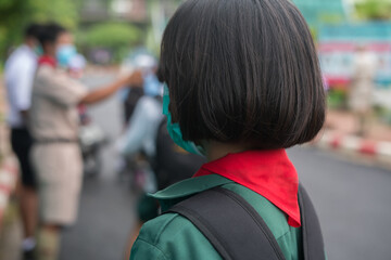 Uniform student in protective face masks standing at the school