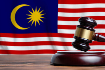 Justice and court concept in Malaysia. Judge hammer on a flag background