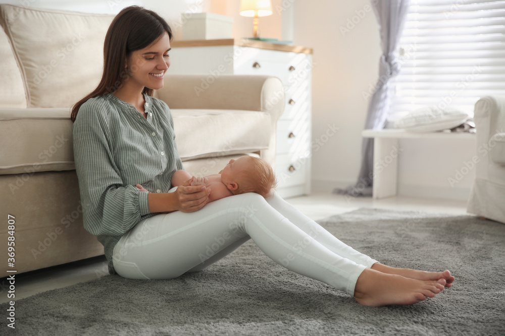 Sticker Mother with her newborn baby at home