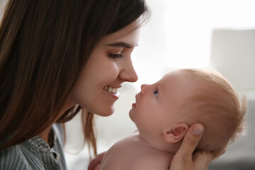Mother with her newborn baby at home, closeup