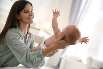 Fototapeta premium Mother with her newborn baby at home