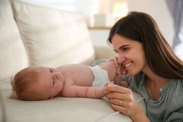Obraz na płótnie Canvas Mother with her newborn baby at home