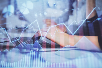 Multi exposure of woman hands typing on computer and financial graph hologram drawing. Stock market analysis concept.