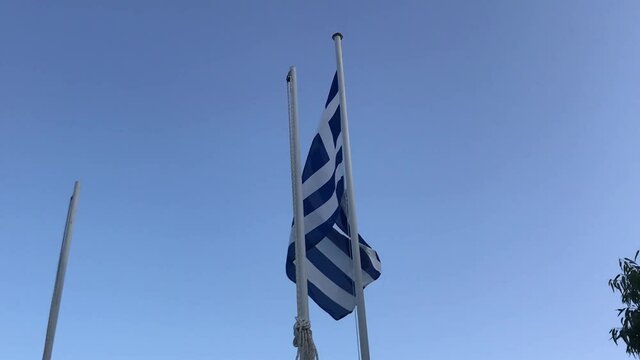 Large epic Greek flag waving majestically in the sunlight.
Gimbal orbit shot in slow-motion.