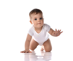 Portrait of sweet cute baby boy toddler in white body crawling on floor with hand raised and...
