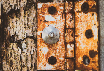 Old lock on a weathered wooden door