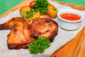 Juicy BBQ chicken leg quarters with fried potato. Food to go