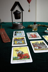 Tarot cards, candle, incense, sage, cauldron and essence.