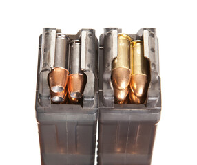 Two rifle magazines filled with rounds, shot on a white studio background.